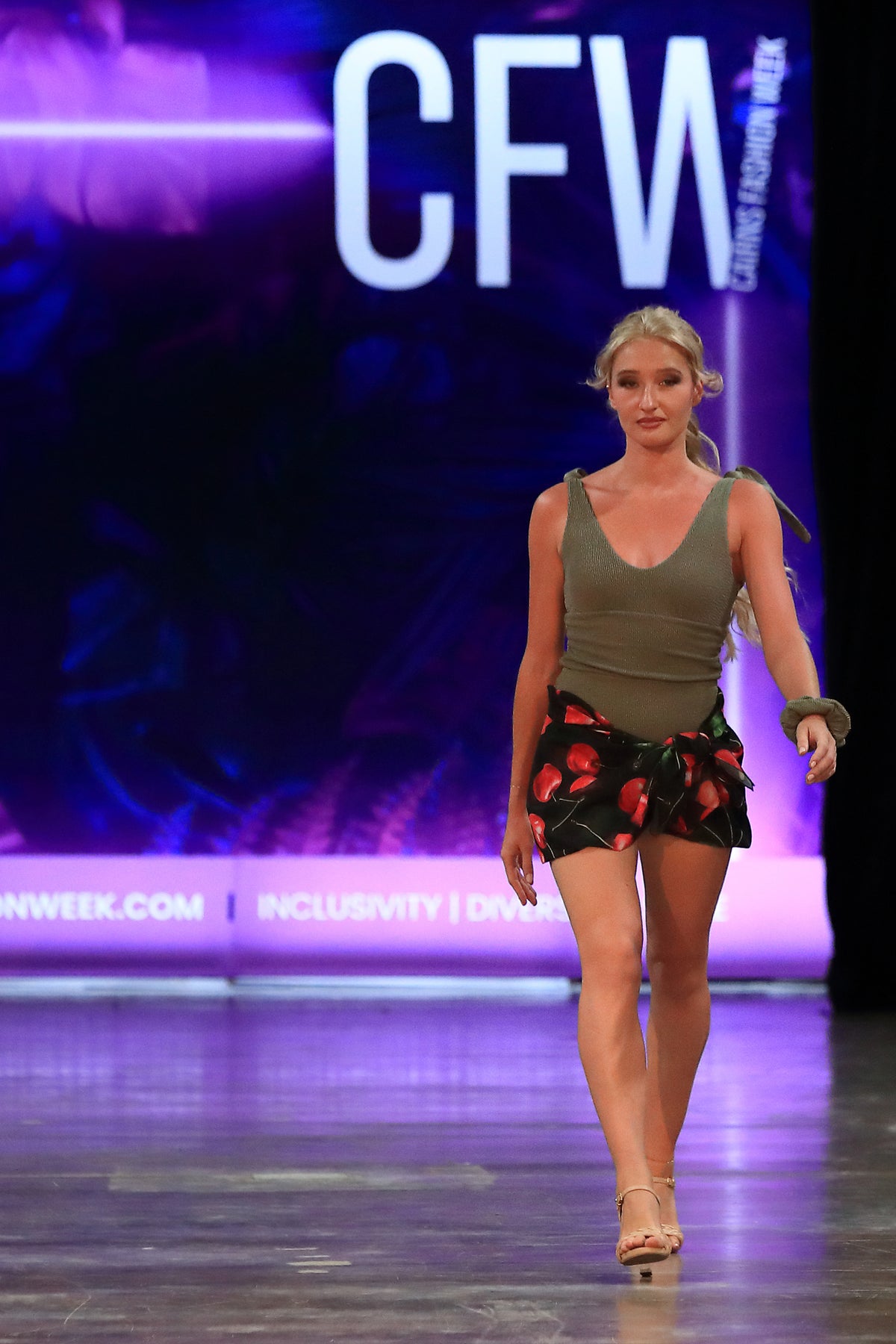 Model wears the VIŠNJA cherry chiffon sarong on the runway