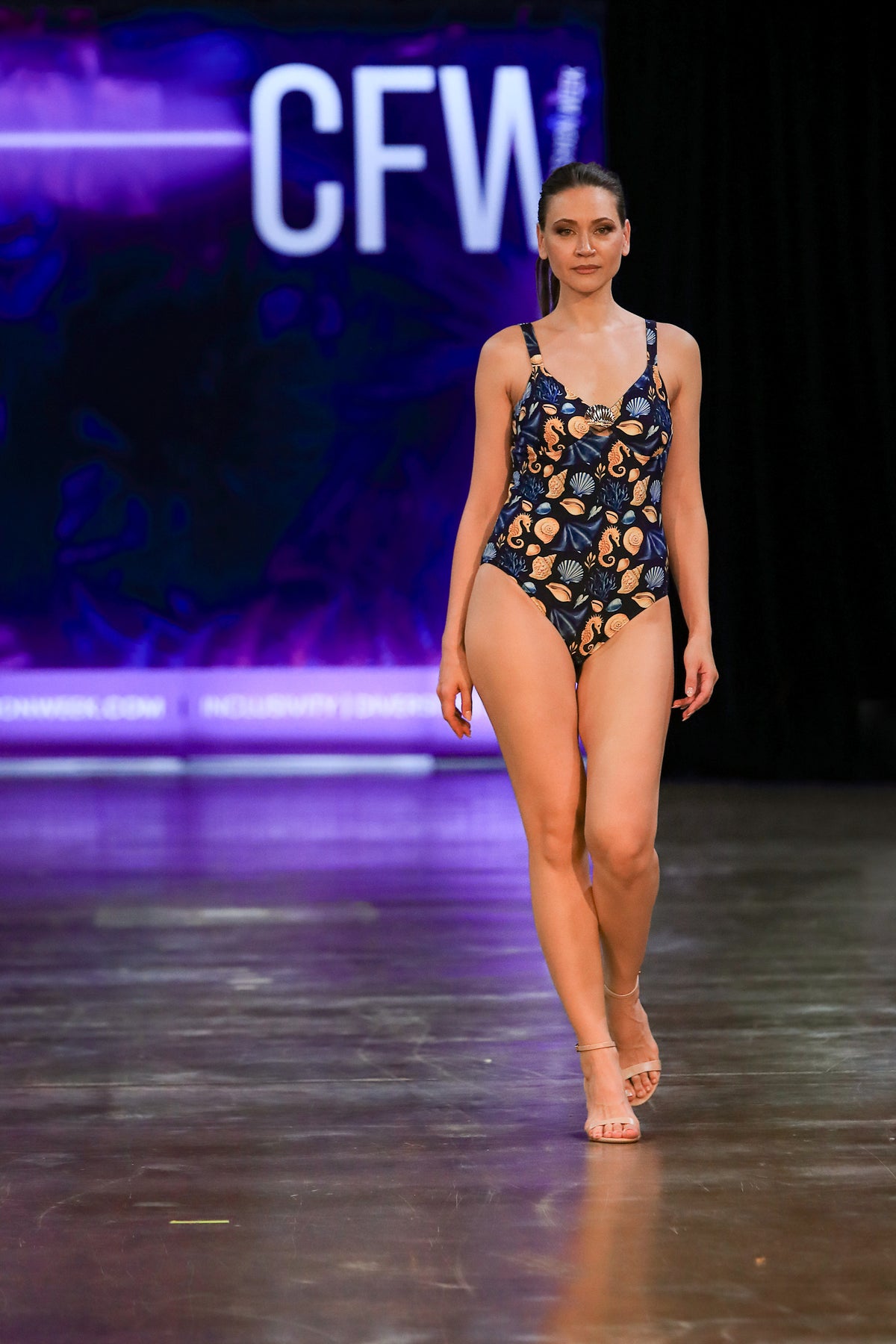 Model wears the ISABELLA Čiovo one piece swimsuit on the runway