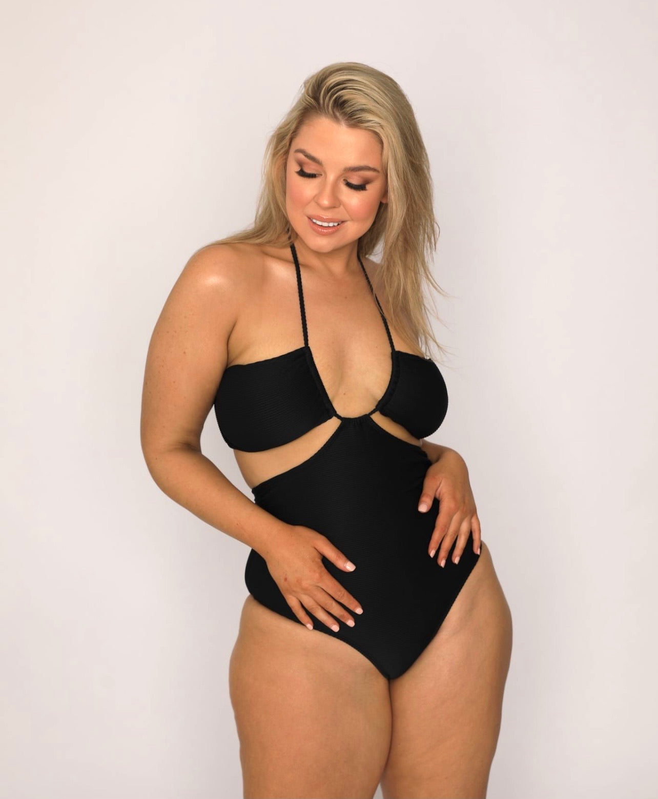 Black cut out style tie up versatile one piece 5 way swimsuit in ribbed fabric.